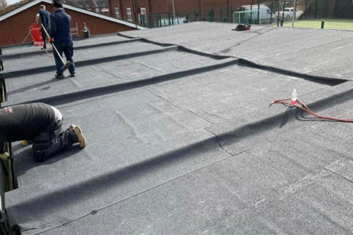 Flat roof under constrction using roofing felt product